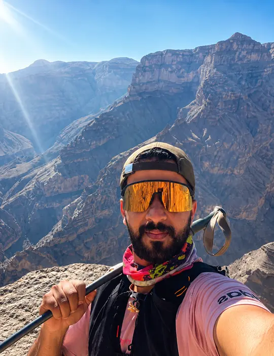 Guide pausing on the rocks above the canyon