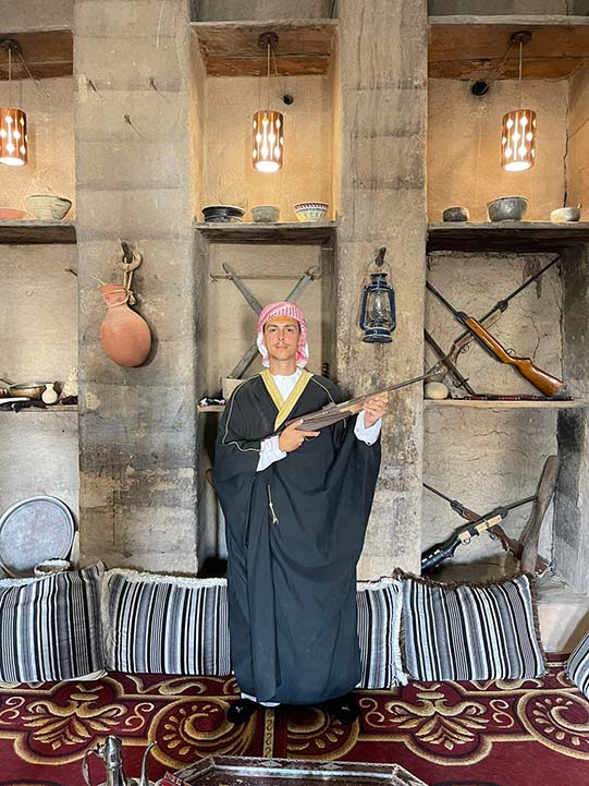 a boy with play gun inside Bait Al Safah