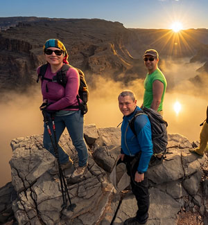 Traveller on a rock platform above the clouds