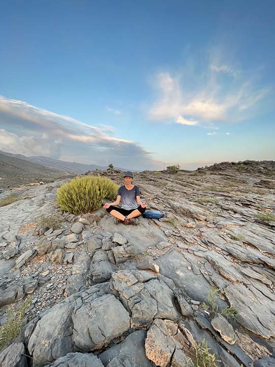 girl sitting in Misfat Al Abriyyin rock