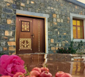 Carved wooden door of the villa after rain