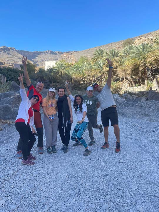 guests posing for photo during wadi ghul adventure tour