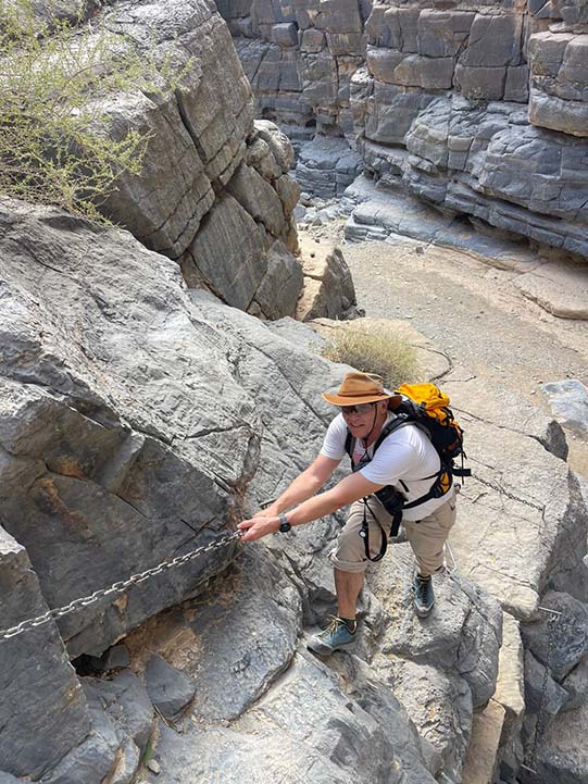 mountain climbing during wadi ghul adventure tour