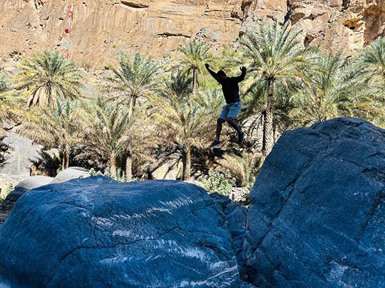 guest jumping on the rock during wadi ghul adventure tour