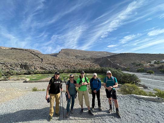 guest posing for photo on the rock during wadi ghul adventure tour