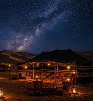 Tents of a desert camp at night in Wahiba Sands with stars above the dunes